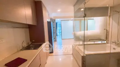 Modern apartment interior with open layout featuring kitchen and bathroom