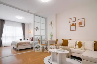 Modern open-plan living room with cozy decor and bedroom view