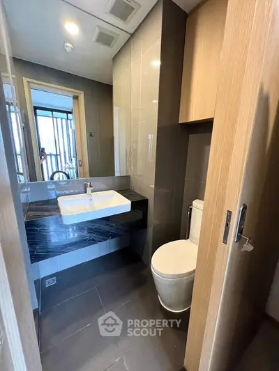 Modern bathroom with sleek design and stylish fixtures in a contemporary apartment.
