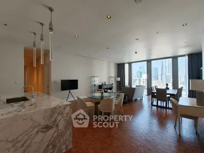 Luxurious open-plan living room with stunning city view and elegant marble kitchen island.
