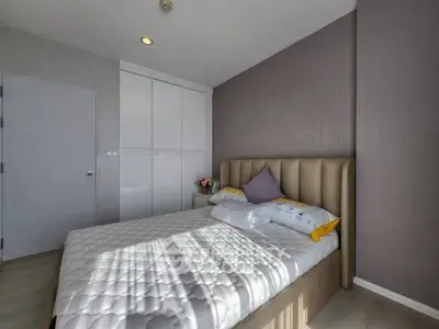 Modern bedroom with stylish decor and ample natural light
