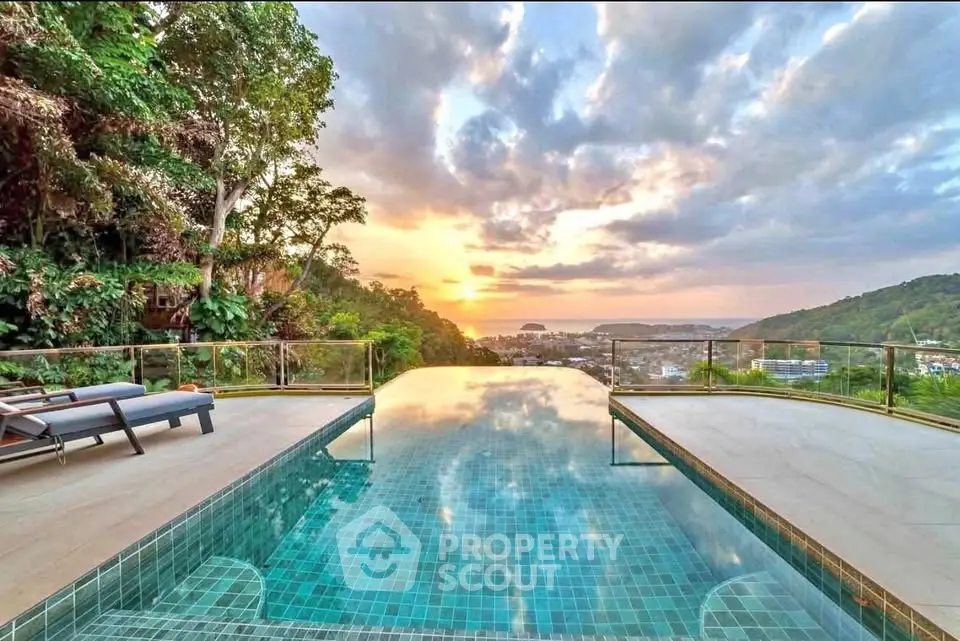 Stunning infinity pool with breathtaking sunset view over lush landscape and distant cityscape.