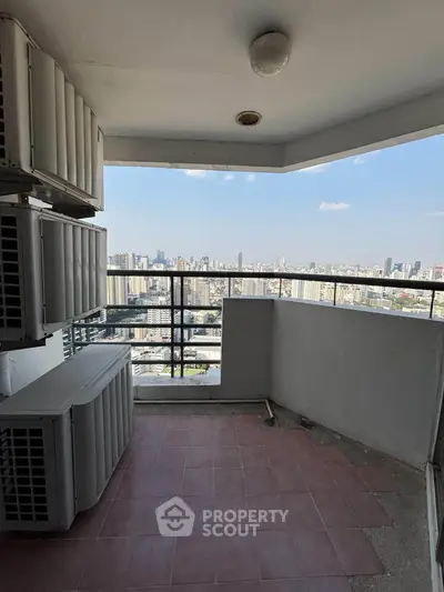 Spacious balcony with stunning city skyline view, perfect for relaxation and enjoying urban living.