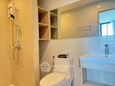 Modern bathroom with sleek fixtures and large mirror in a contemporary apartment.