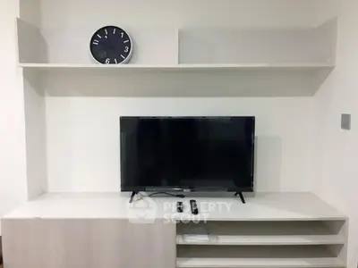 Modern living room with sleek TV unit and wall-mounted clock, perfect for contemporary homes.