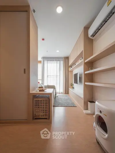 Modern living room with sleek design, featuring built-in shelves and natural light.