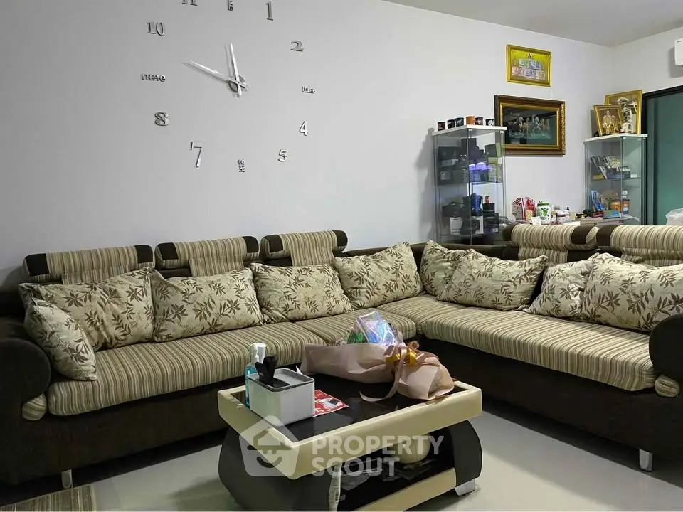 Spacious living room with stylish sofa and modern decor, perfect for relaxation and entertaining guests.