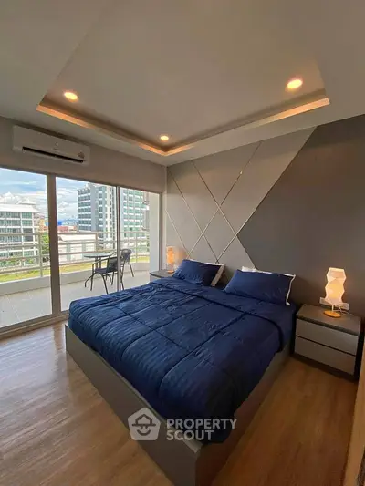 Modern bedroom with large windows and balcony view in a stylish apartment