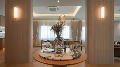 Luxurious modern living room with elegant decor and ambient lighting, featuring a stylish marble table centerpiece.