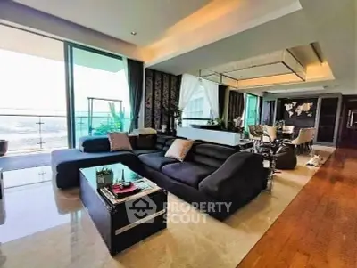 Luxurious living room with modern decor and expansive balcony view