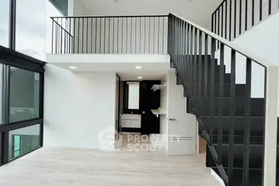 Modern duplex apartment with sleek staircase and large windows