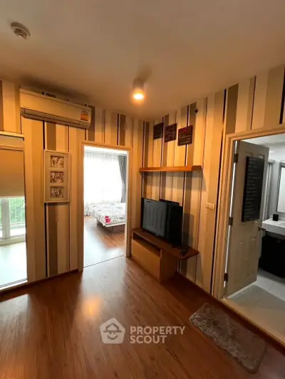 Charming apartment interior with cozy living area and stylish decor, featuring a glimpse into a bright bedroom.