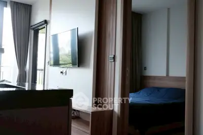 Modern apartment interior with sleek TV setup and cozy bedroom view.
