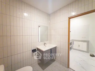 Modern bathroom with sleek vanity and tiled walls