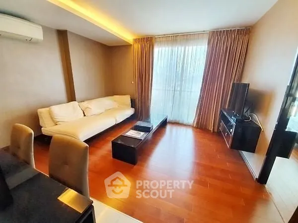 Spacious living room with modern decor and large windows for natural light.