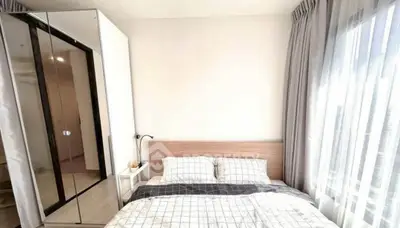Bright and cozy bedroom with large window and modern decor