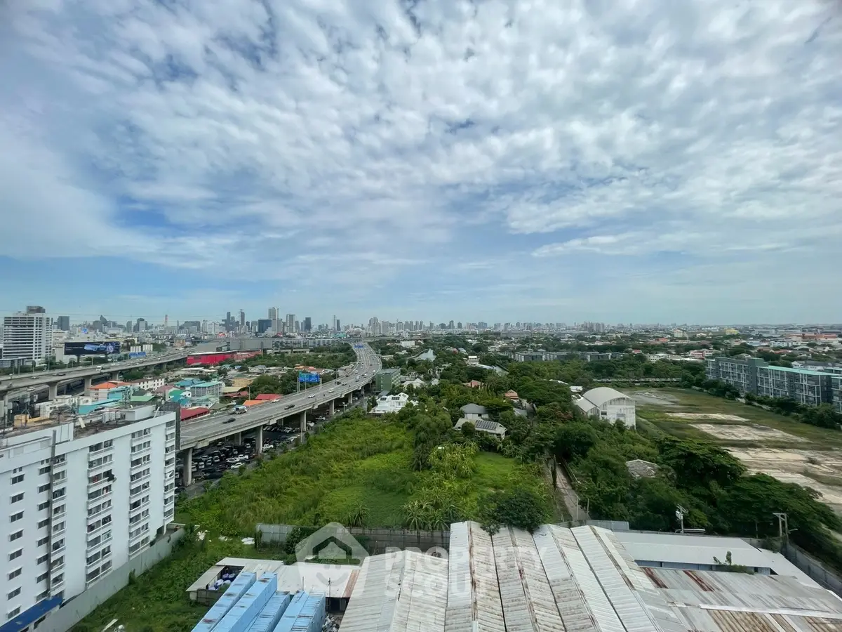 Stunning cityscape view from high-rise building with lush greenery and expansive skyline.
