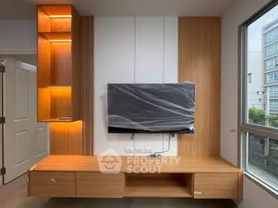 Modern living room with mounted TV and stylish wooden cabinetry