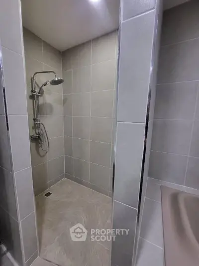 Modern bathroom with sleek shower design and neutral tiles