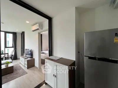 Modern apartment interior with open living room and kitchen featuring sleek furniture and natural light.