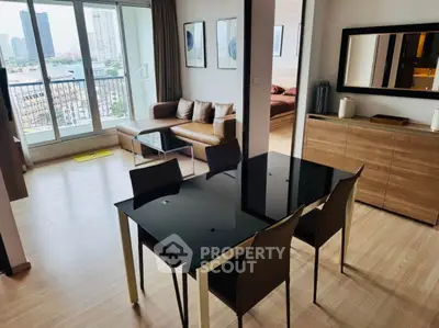 Modern open-plan living and dining area with city view and stylish furnishings.