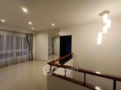 Spacious modern interior with elegant lighting and large windows, perfect for stylish living.