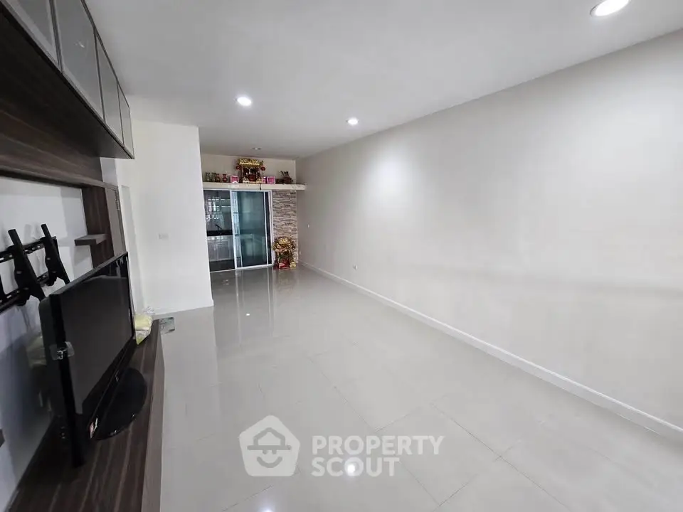 Spacious living room with modern design and ample natural light, perfect for family gatherings.