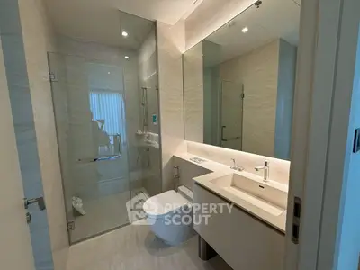 Modern bathroom with glass shower and sleek fixtures