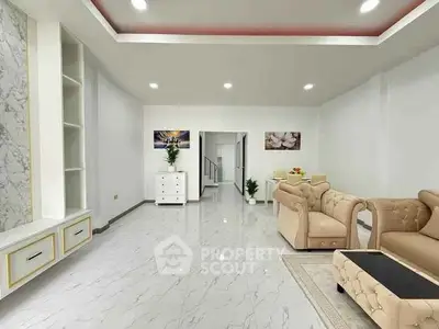 Spacious modern living room with elegant marble flooring and plush seating.