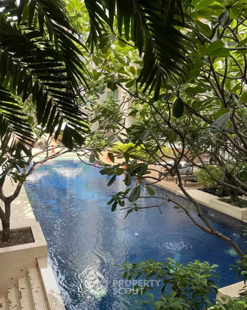 Luxurious residential pool surrounded by lush greenery, offering a serene oasis in the heart of the city.