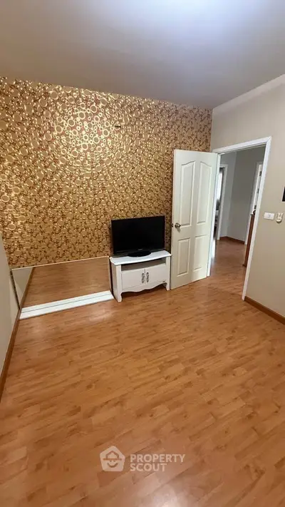 Chic living room with stylish wallpaper and sleek wooden flooring