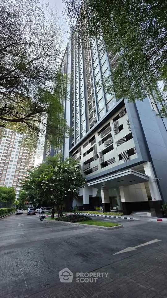 Stunning high-rise building exterior with lush greenery and modern architecture.
