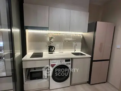 Modern compact kitchen with sleek appliances and under-cabinet lighting