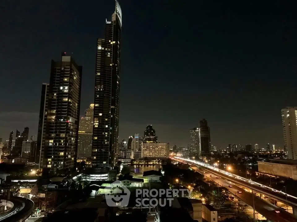 Stunning night view of city skyline with illuminated skyscrapers and bustling roads.