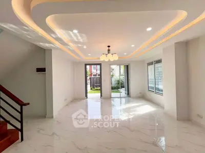 Spacious modern living room with elegant lighting and marble flooring, perfect for family gatherings.