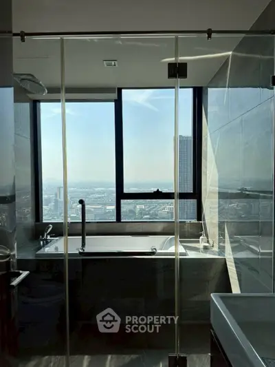 Luxurious bathroom with stunning city view from large window, featuring modern fixtures and elegant design.