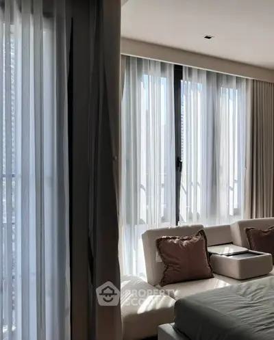 Luxurious bedroom with elegant curtains and plush pillows, offering a serene and stylish ambiance.