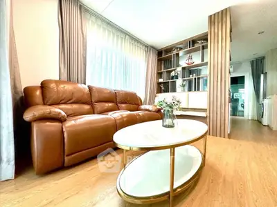 Spacious living room with leather sofa and elegant decor in modern apartment