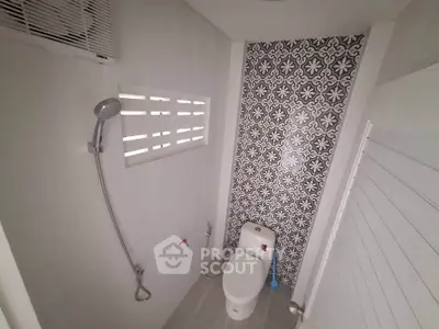 Modern bathroom with stylish patterned tiles and sleek fixtures