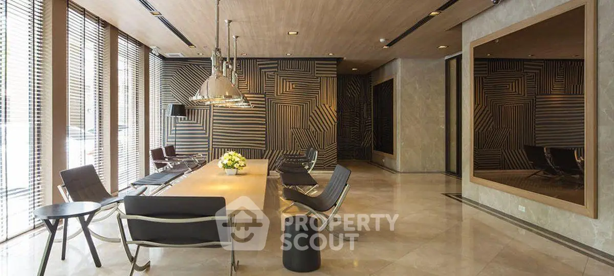 Luxurious modern lobby with stylish seating and geometric wall design, perfect for upscale living.