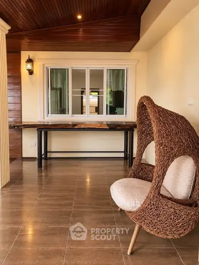Charming interior with unique wicker chair and wooden accents, perfect for cozy living spaces.