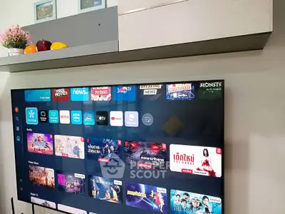 Modern living room with wall-mounted TV and sleek shelving unit.