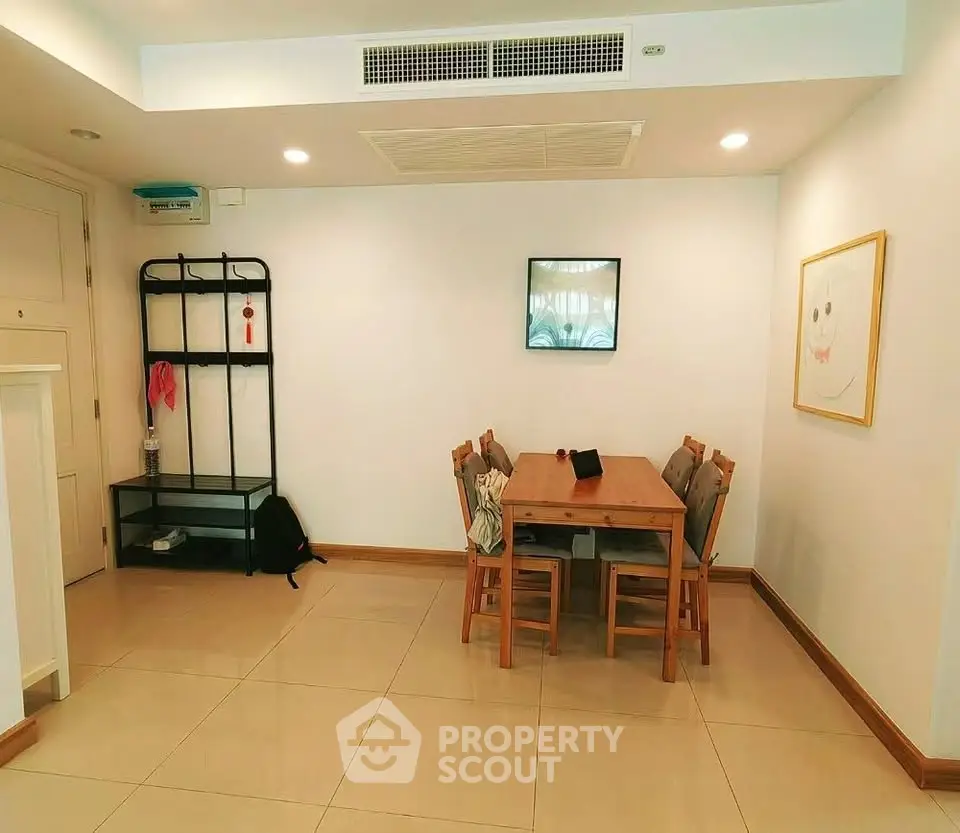 Spacious dining area with modern furniture and minimalist decor in a bright apartment.