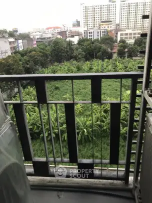 Charming balcony view overlooking lush greenery and cityscape, perfect for relaxation and enjoying nature.