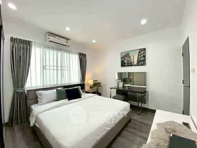Spacious modern bedroom with elegant decor and natural light