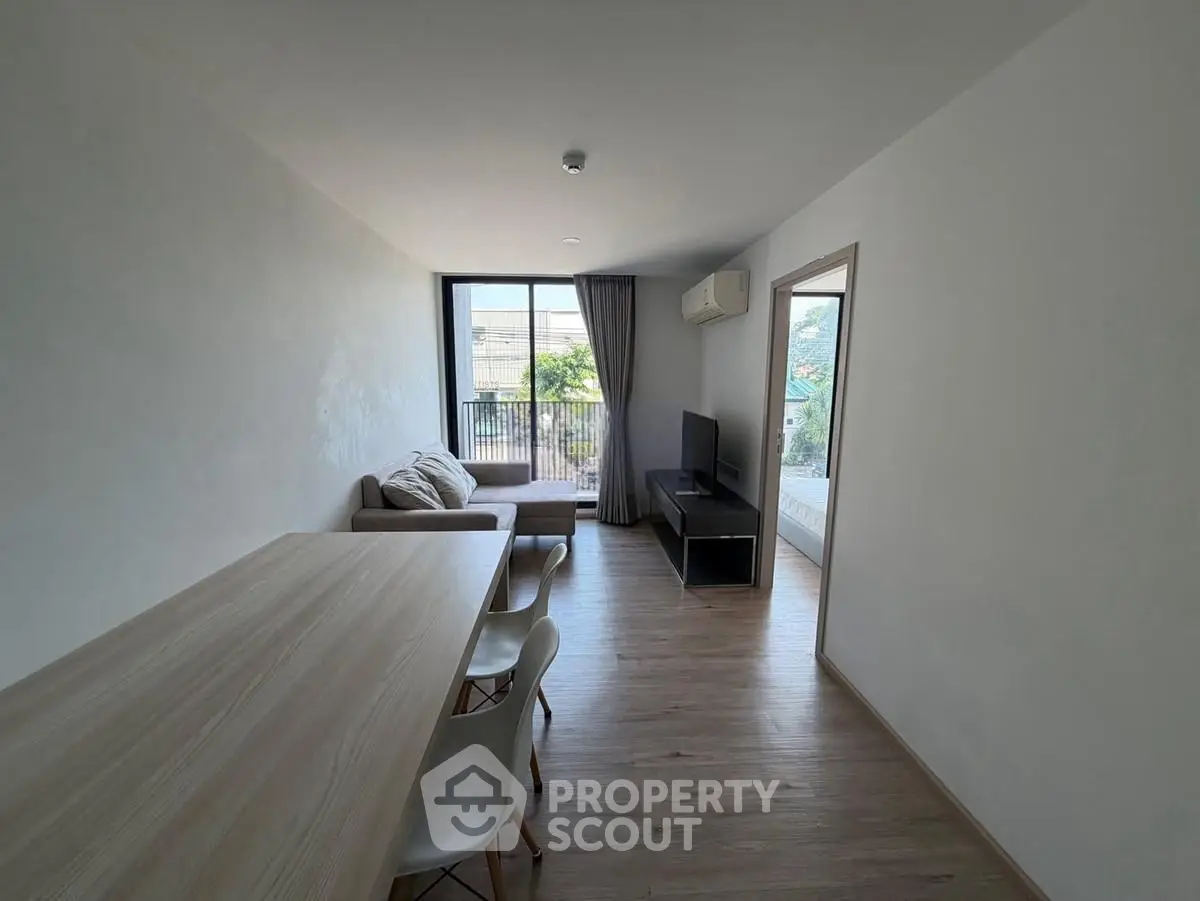 Modern living room with sleek furniture and natural light, perfect for urban living.