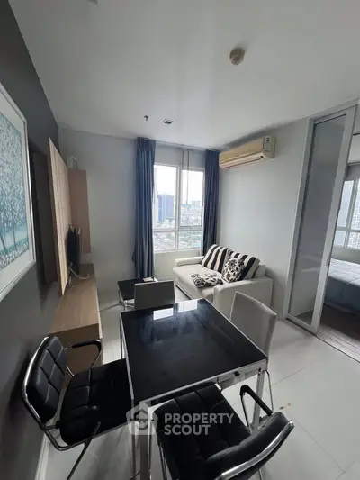 Modern living room with city view, sleek furniture, and stylish decor in a high-rise apartment.