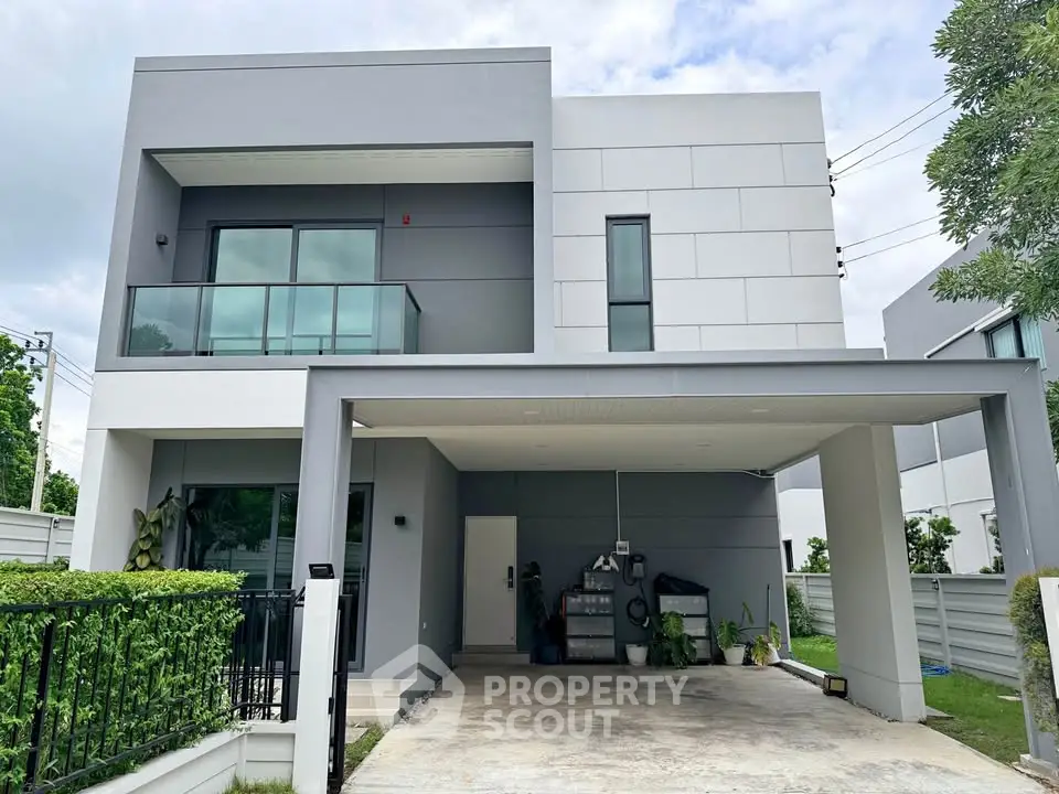 Modern two-story house with sleek design and spacious carport in a serene neighborhood.