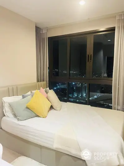 Modern bedroom with city view, cozy bed and stylish decor, perfect urban living space.