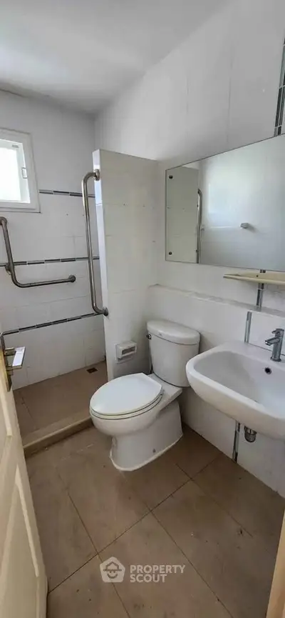 Compact bathroom with accessible features and modern fixtures.